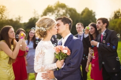 Newlyweds kissing at wedding reception