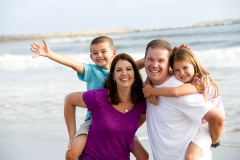 Happy loving family playing on the beach