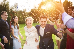 Newlyweds with guest on their garden party